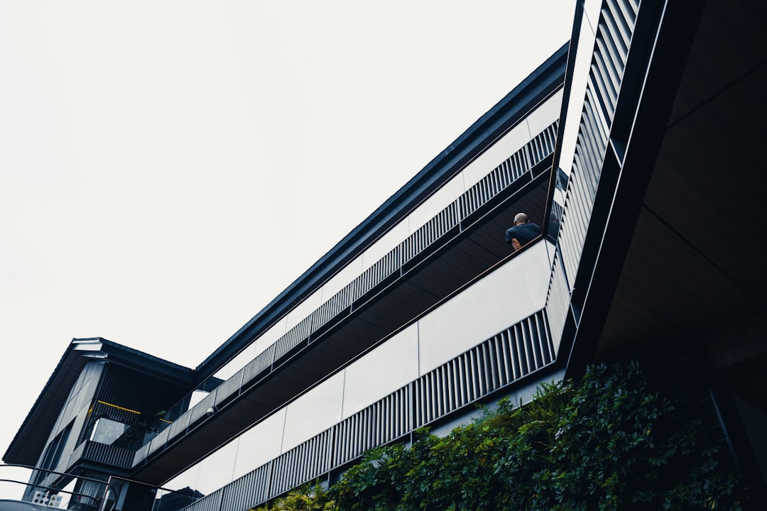 HVAC technician contemplating near a commercial building
