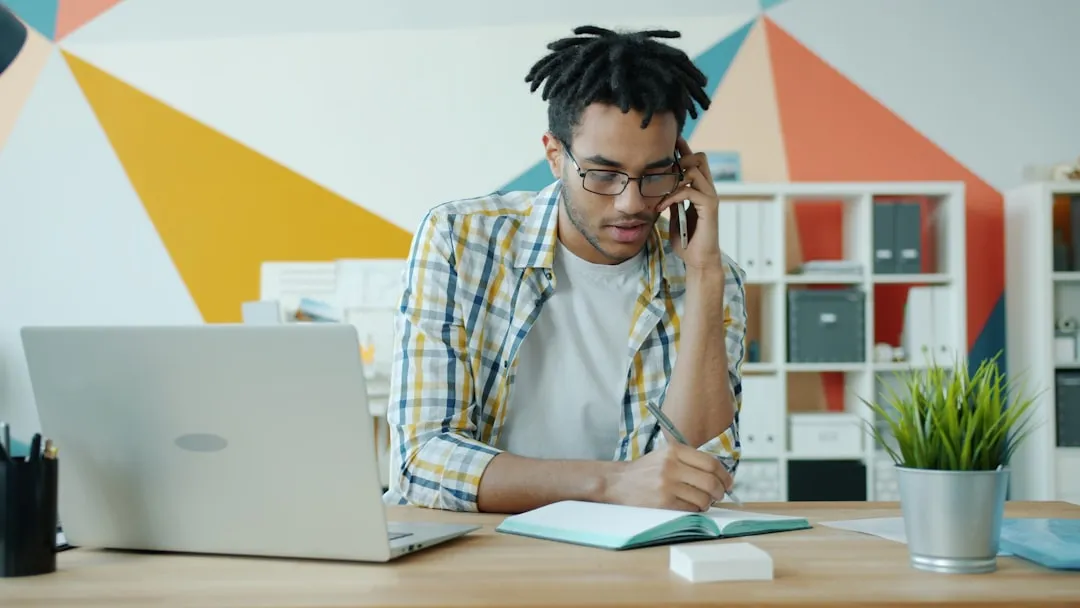 HVAC technician reviewing employee benefits paperwork at a small business office desk