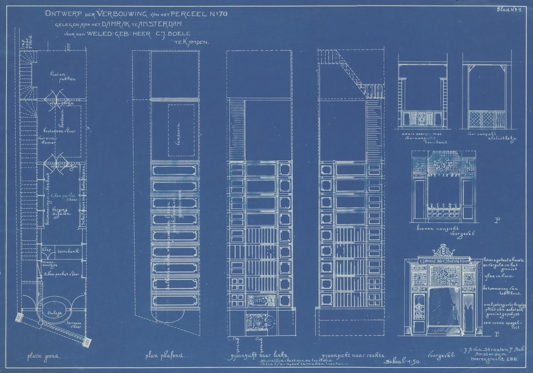 Commercial building blueprints and HVAC mechanical plans on a desk