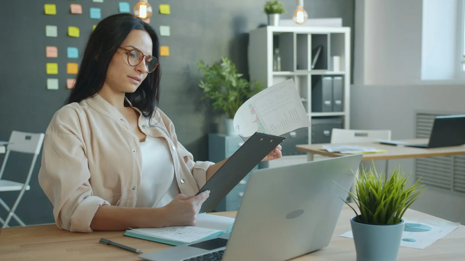 Business owner reviewing financial documents at office desk