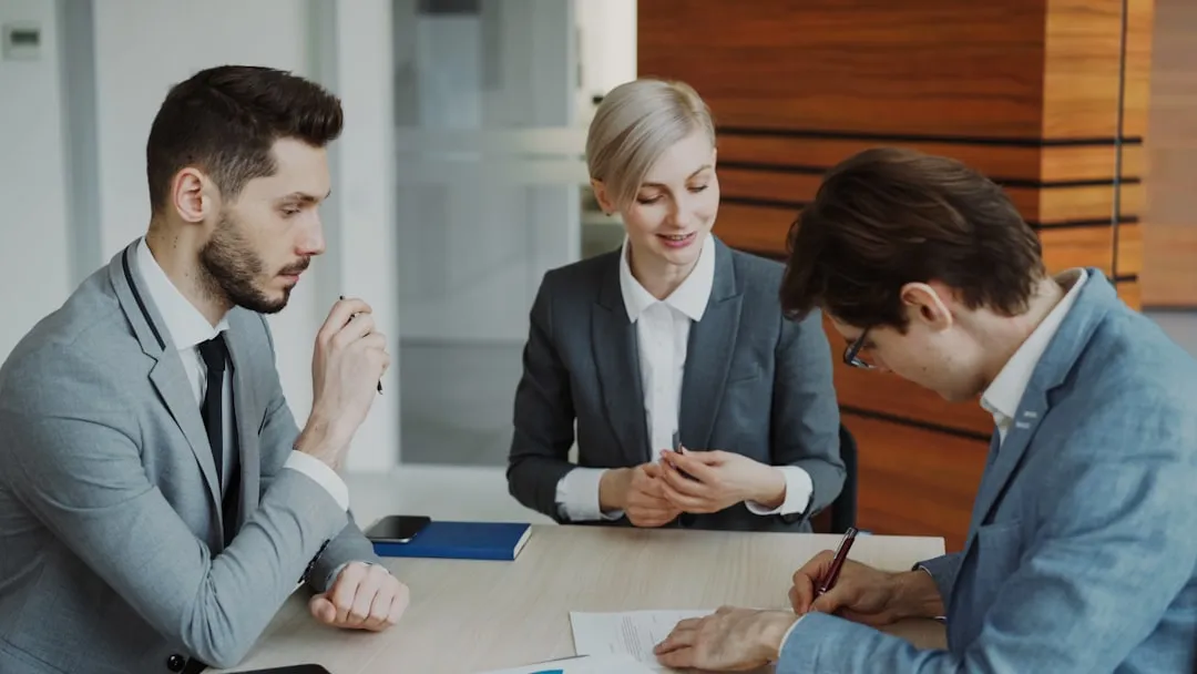 Business professionals reviewing legal documents in an office meeting
