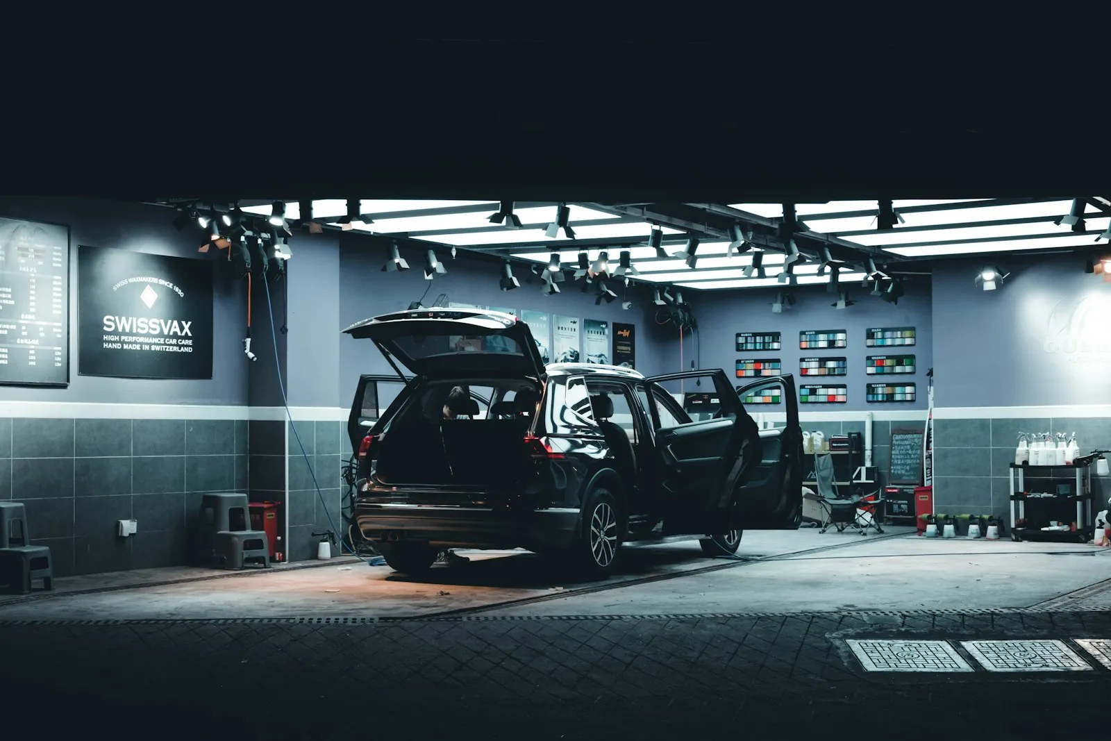 Small HVAC shop owner standing in workshop with service van and tools