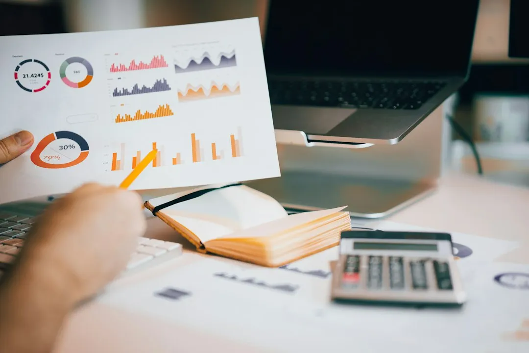 HVAC business owner reviewing financial reports at office desk