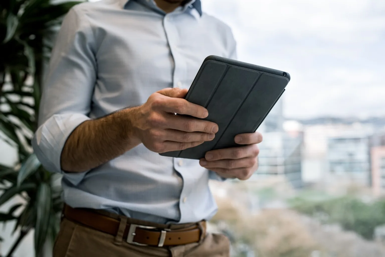 HVAC contractor showing financing options on tablet to homeowner