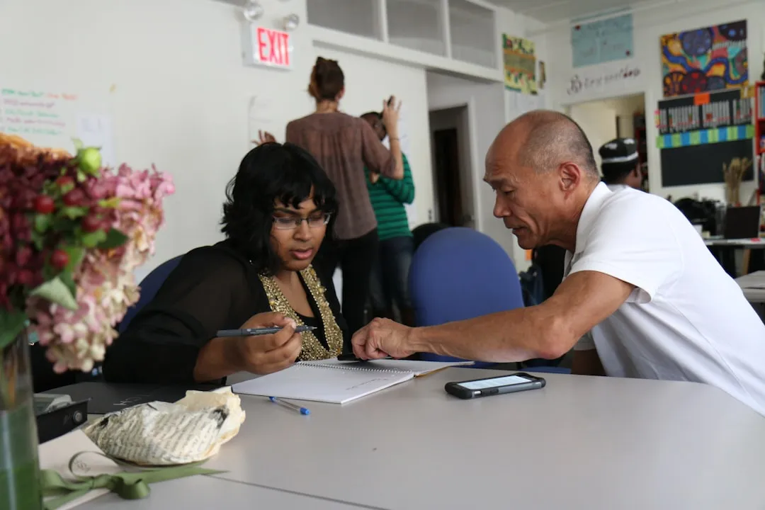 Diverse small business owner signing contract at office desk