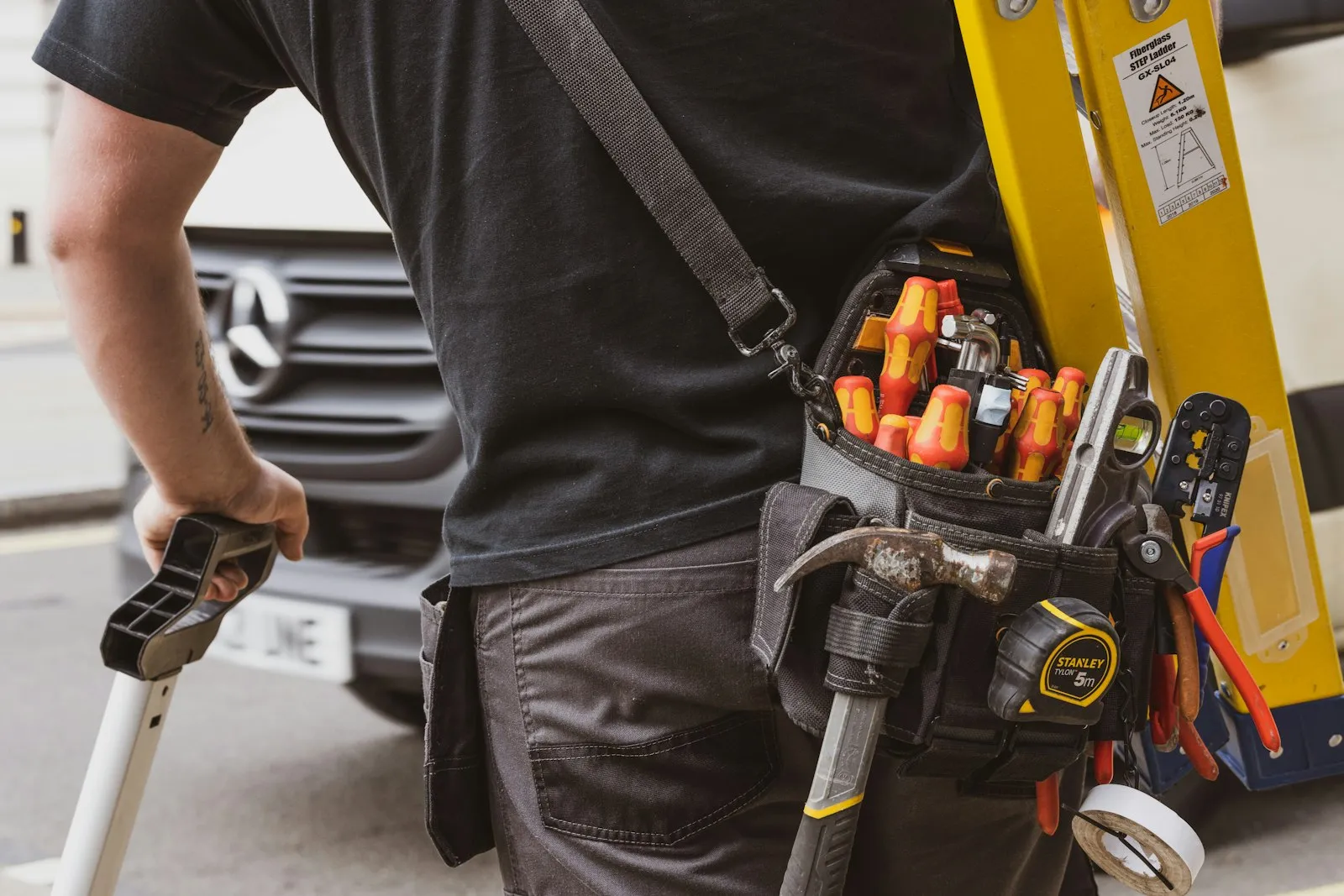 HVAC technician with tools near a service vehicle