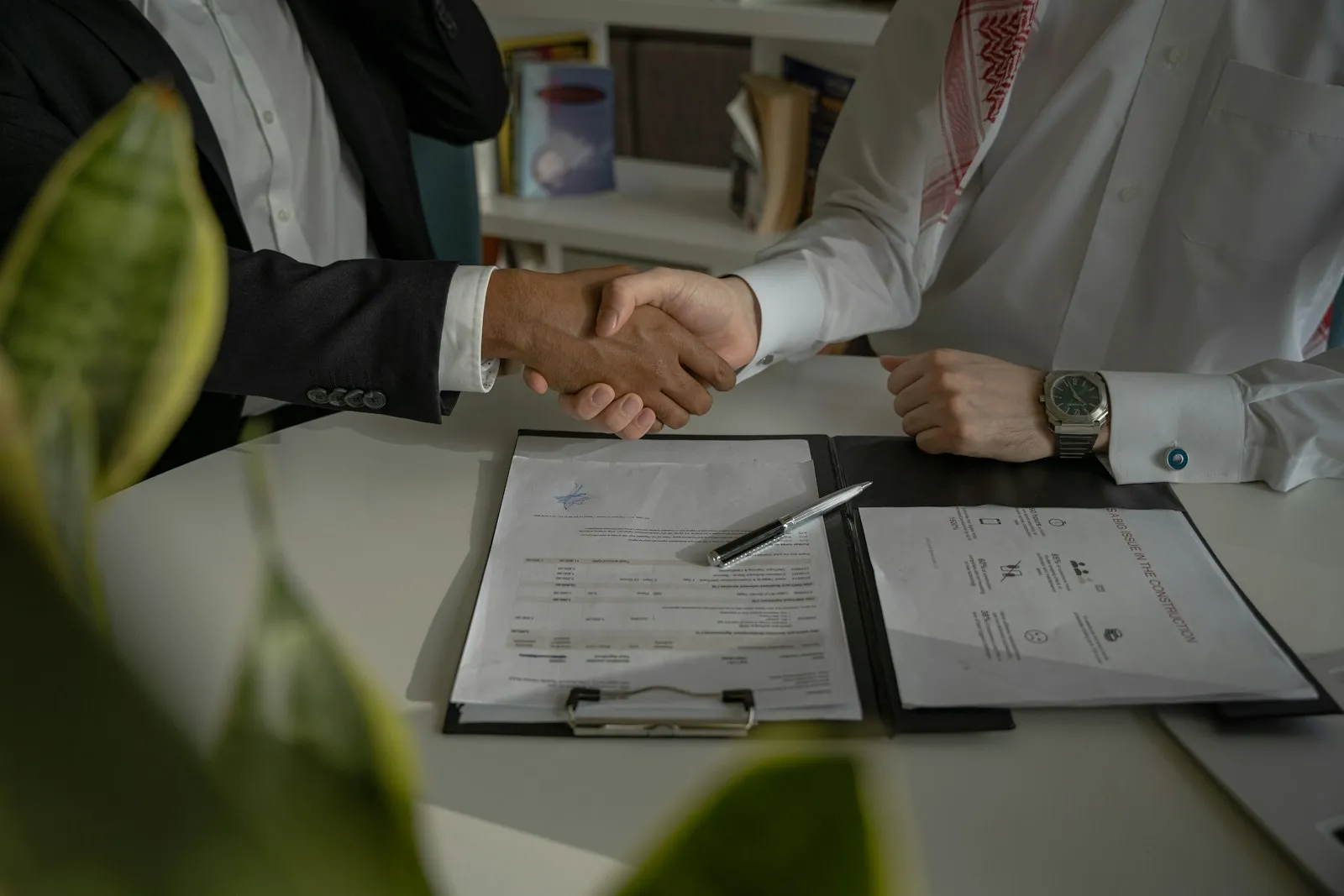 Two people negotiating a business deal across a table