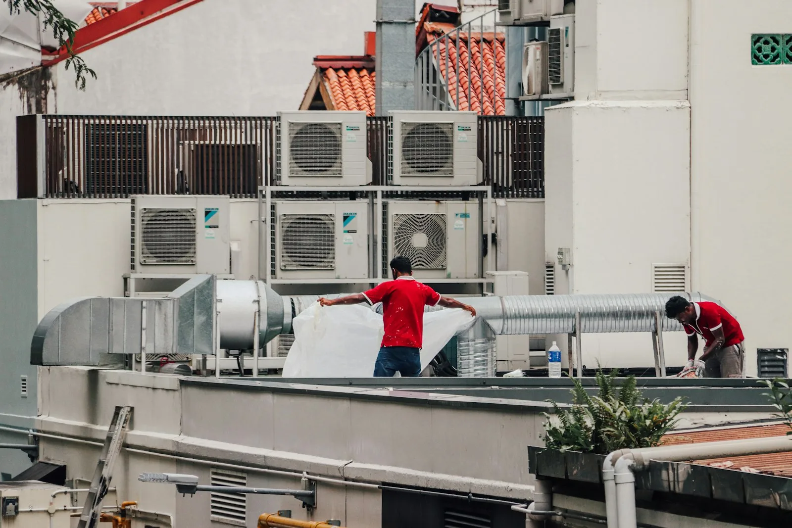 HVAC subcontractor crew working on commercial air conditioning installation